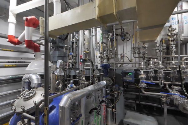 Modern quality control laboratory with technician analyzing TXIB samples using advanced testing equipment